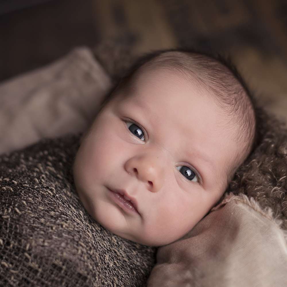 one month old baby swaddled