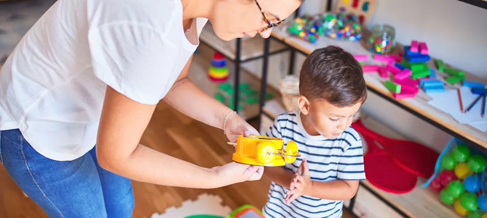 A mother showing a toddler clock to her child.