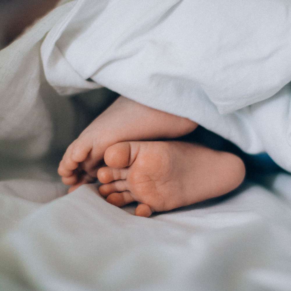 baby's feet in sheets
