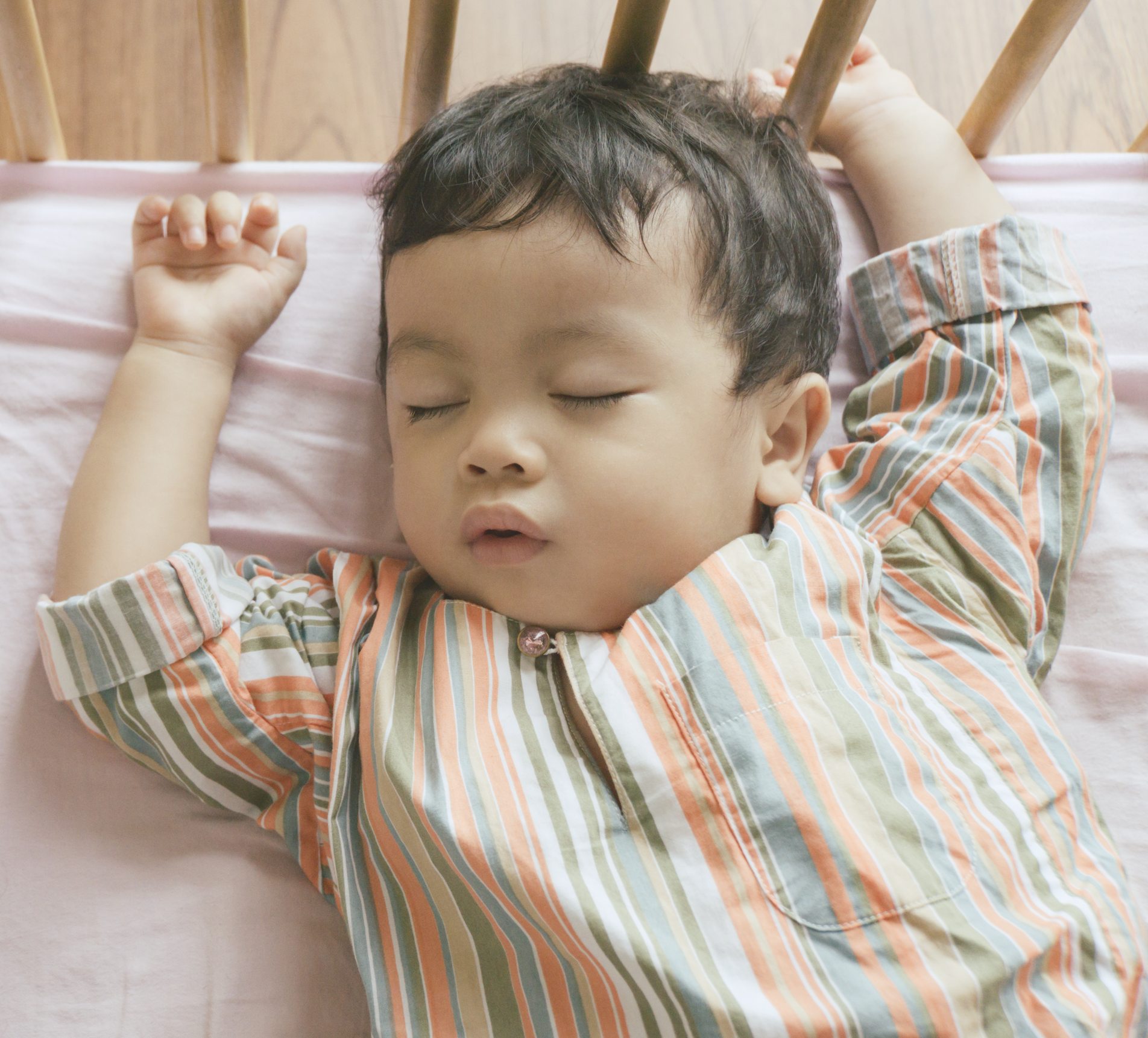 Baby sleeping independently in crib after sleep training 