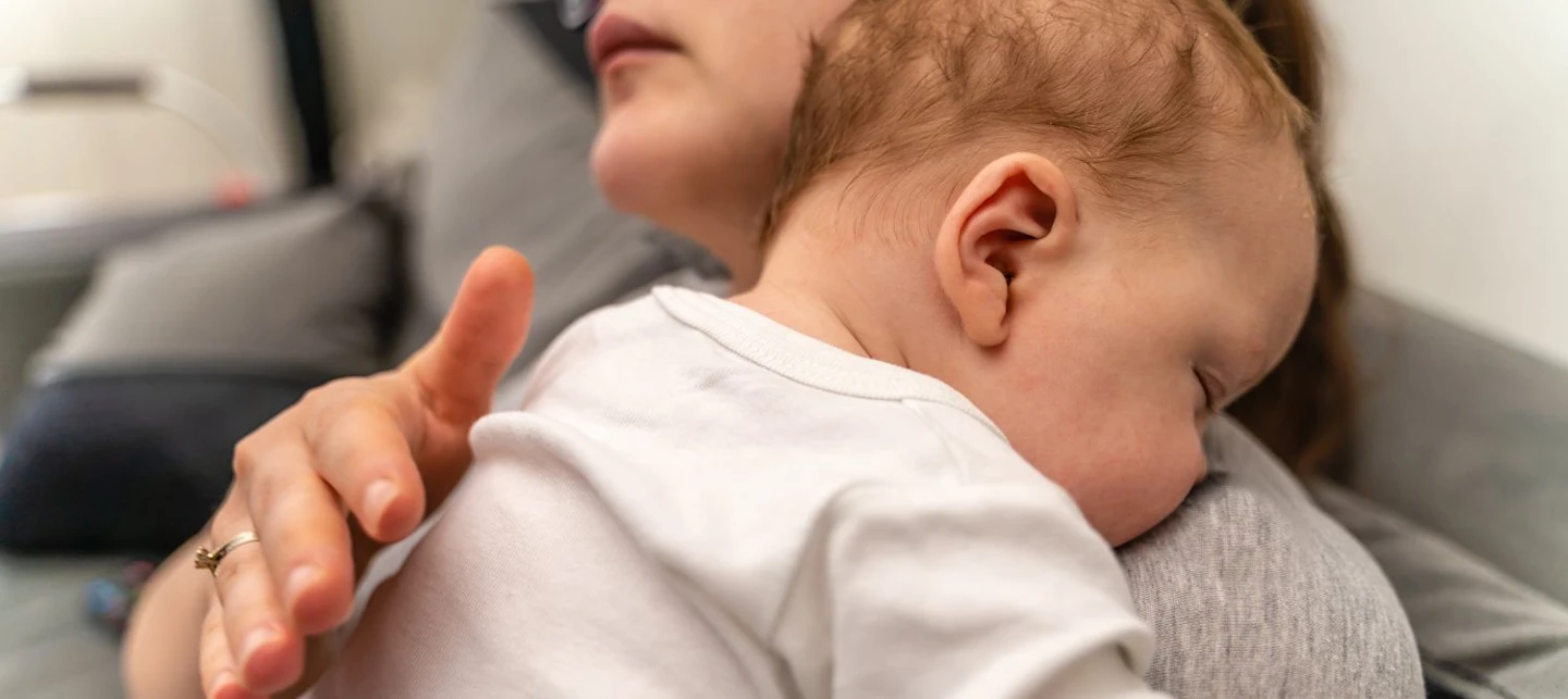 A mother burping her baby. | Huckleberry