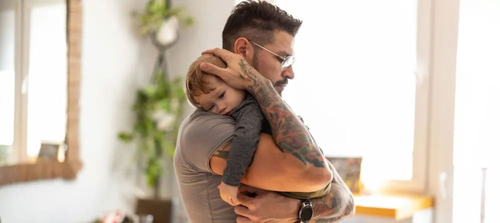 A father holding a child.
