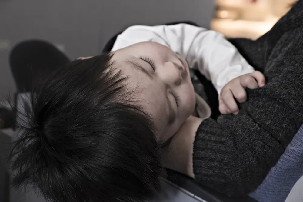 Baby Sleeping In Parents Arms