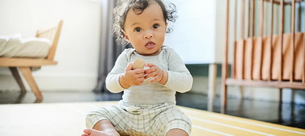 A 10 month old baby playing.