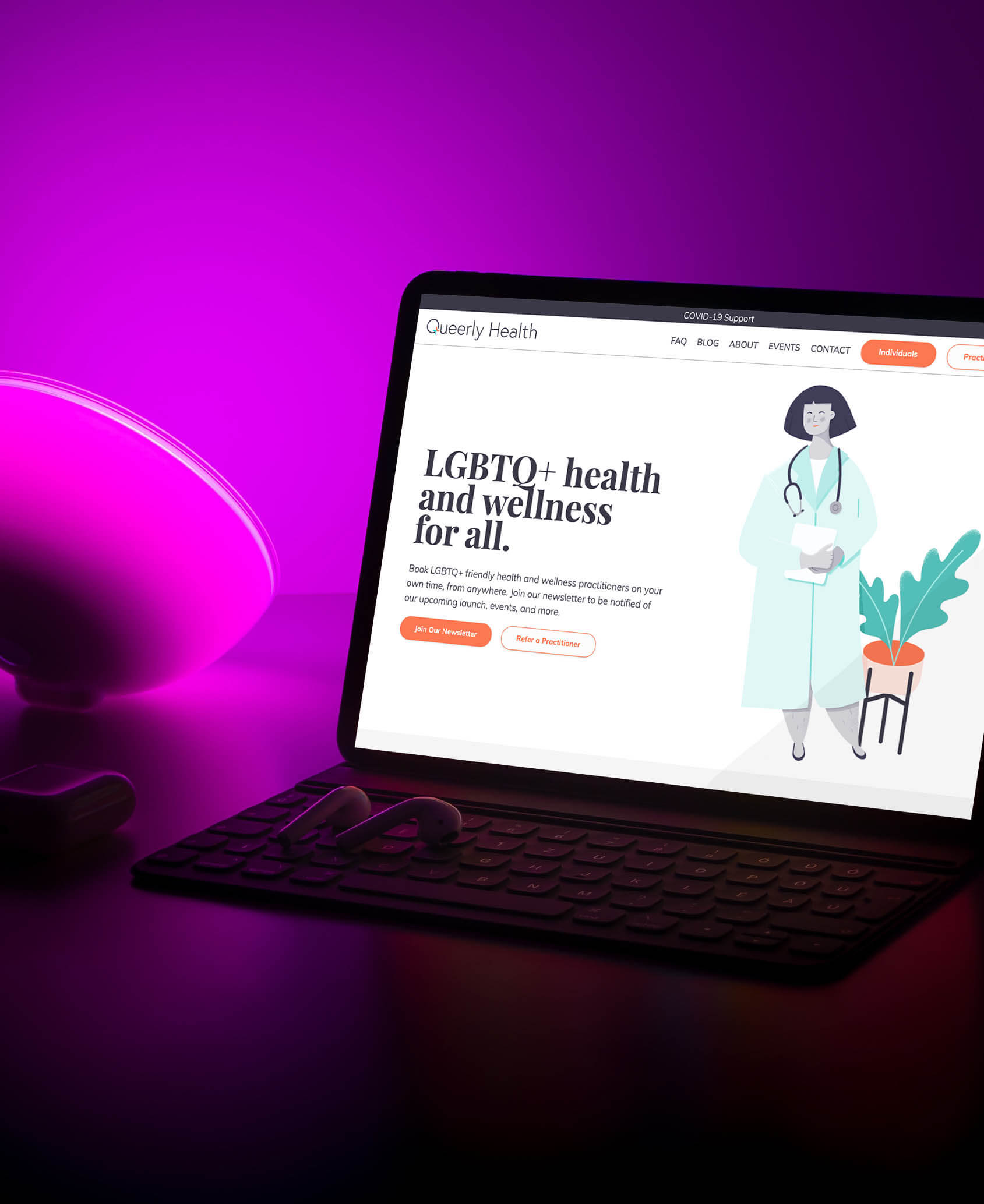 an image of a computer, in a purple room, open to Queerly Health's home page.