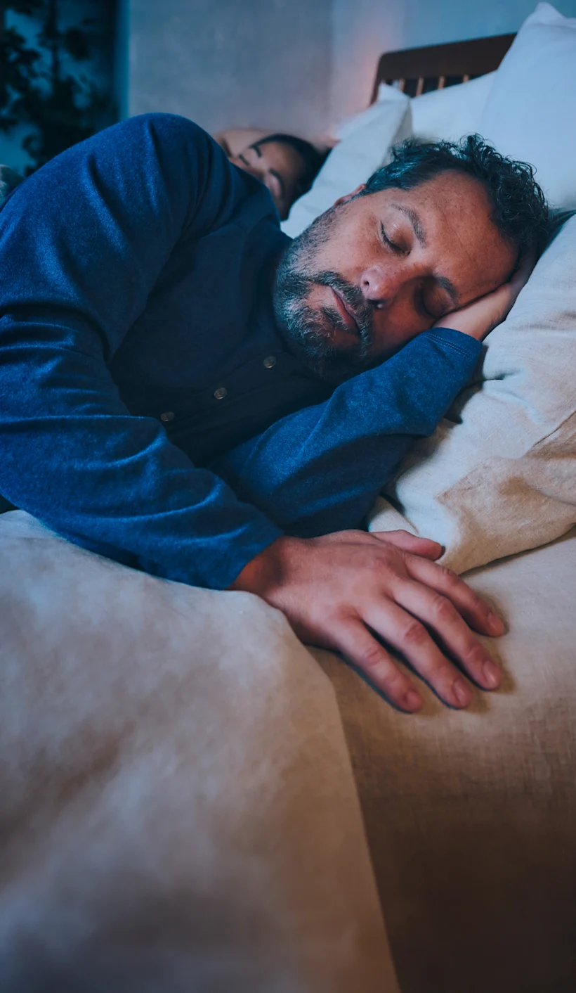 man sleeping in bed soundly Hero Mobile