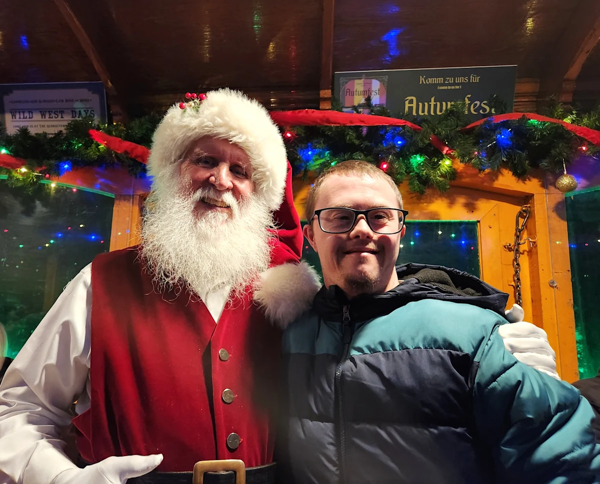 Travis Rice hangs out with Santa Claus during the holidays. Travis has Down syndrome and obstructive sleep apnea (OSA). He can spend more time with others now that he is treating his OSA with Inspire® therapy.