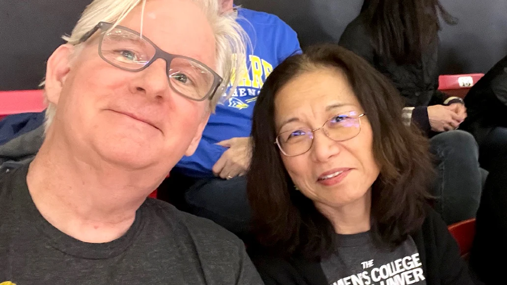 Jim Dooley and his wife Maki Hishikawa watch an Iowa women’s basketball game.