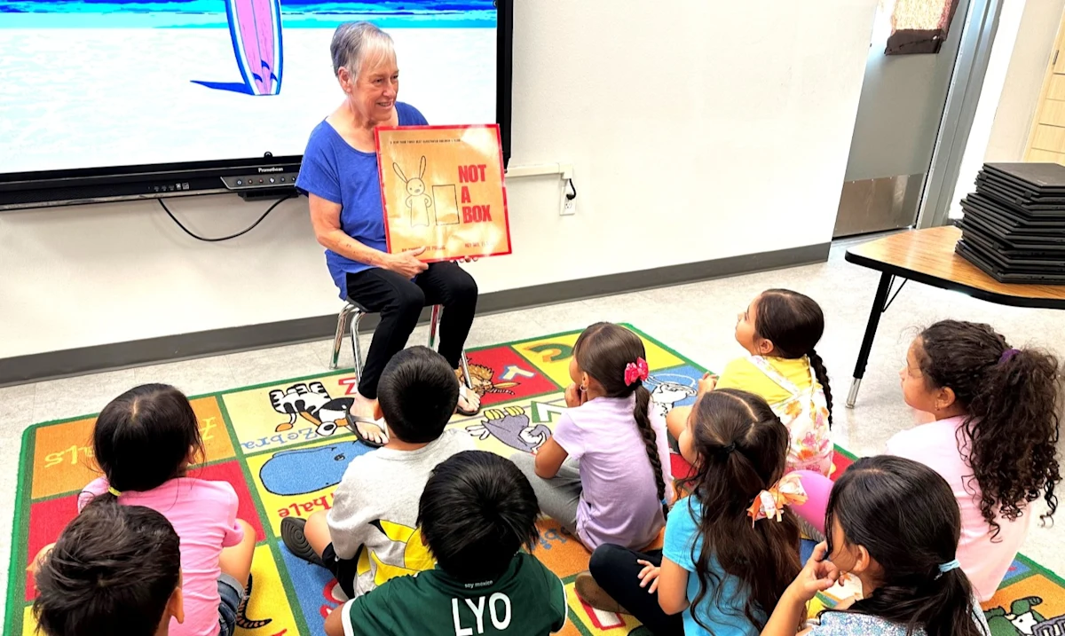 Marie N reads a book to her kindergarten class. Marie has the newest generation of Inspire® therapy, the Inspire V™ implant, to treat her severe obstructive sleep apnea. She said she is sleeping better, and her sleep apnea episodes are down from 35 to 3.