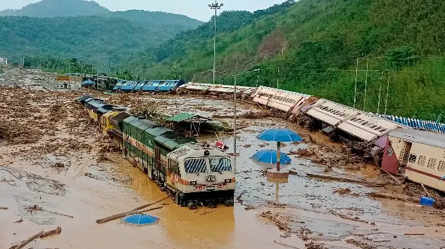 Train coaches are seen toppled over following mudslides at New Haflong railway station on the Lumding-Silchar route at Dima Hasao district