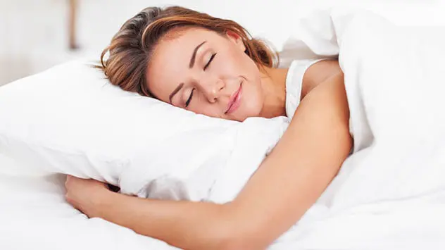 Zeitumstellung Frühling Tipps Frau liegt im Bett und schläft