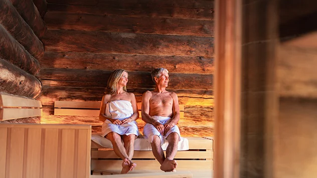 Ein Paar sitzt in der Sauna. 