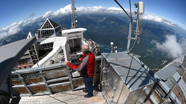 Ein Wetterbeobachter des DWD auf der Zugspitze am Dach der Wetterwarte.