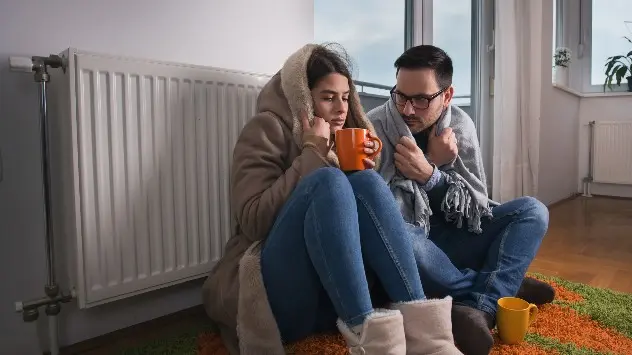 Two people wrap up warm against the cold