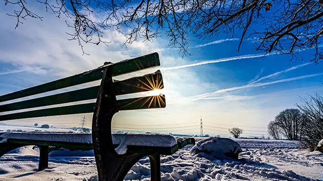 Bank in der Sonne im Schnee