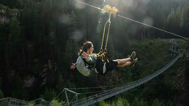 Eine Frau genießt die Fahrt auf dem Ischgl Skyfly. 
