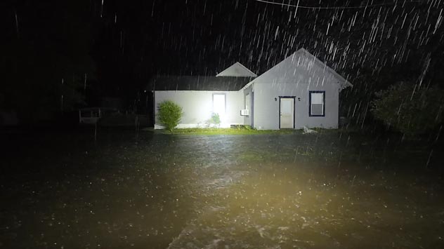 Homes flood to the first floor in Groveton, Texas amid flash flood emergency.