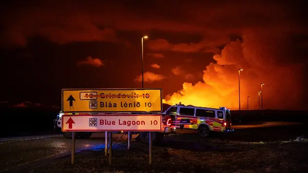 Emergency services on road leading to volcanic eruption