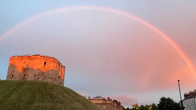 Rainbow arches over Clifford's Tower in York, UK.
