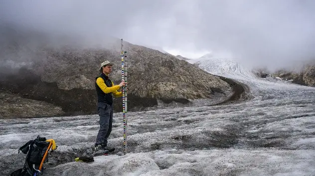 Glaciologist Matthias Huss takes measurements of the melting ice thickness on the tongue of the Gries glacier on September 2nd 2022