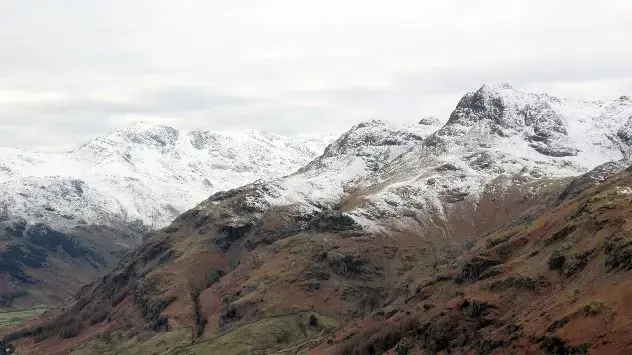 Altitude-driven snow visible as a sharp dividing line in the Langdale Pikes, Lake District.