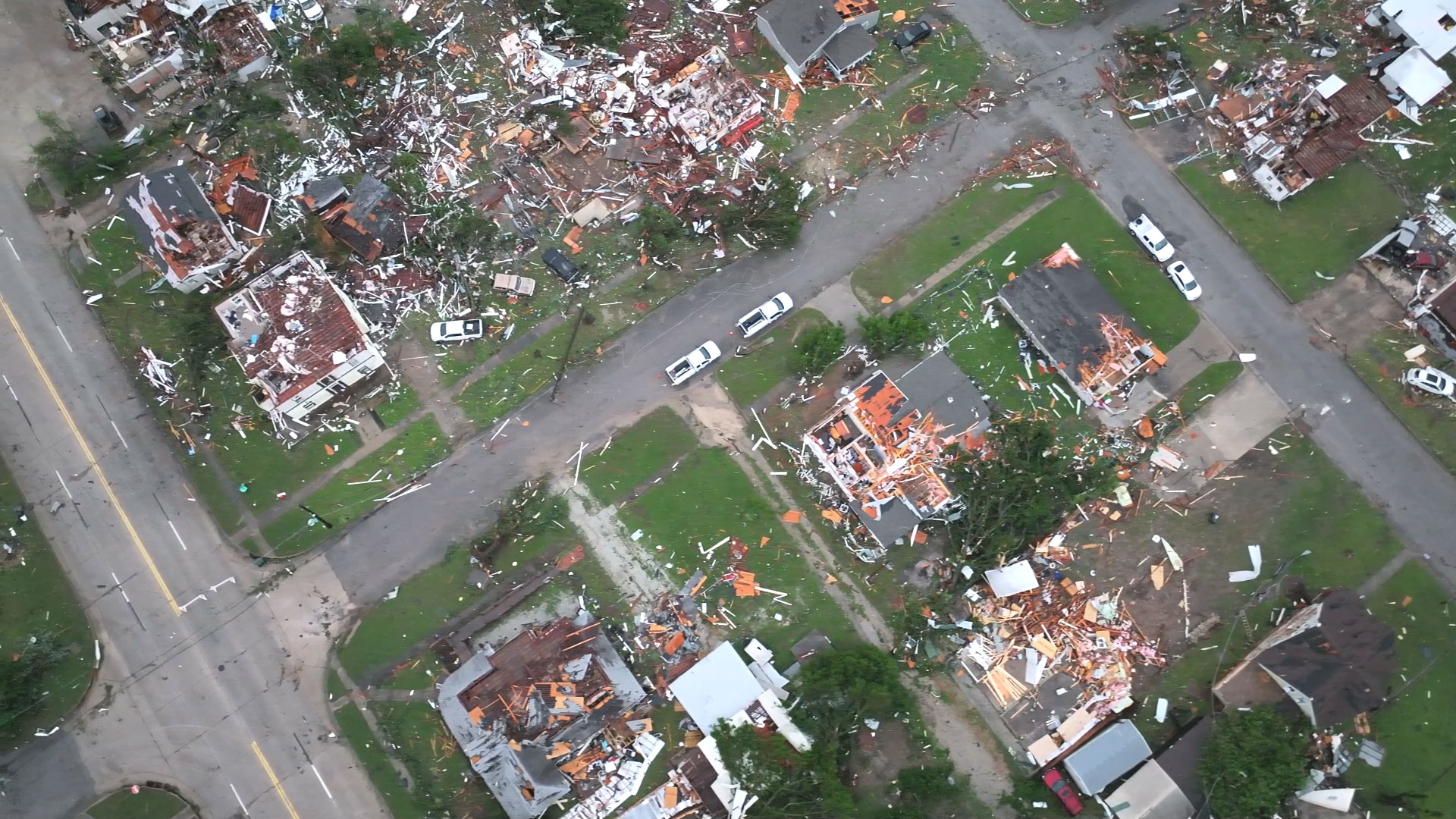 Aerial drone view of partially residential blocks flattened following the tornado passage.
