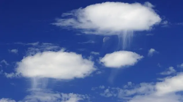 Close-up shot of virga falling from cumulus clouds