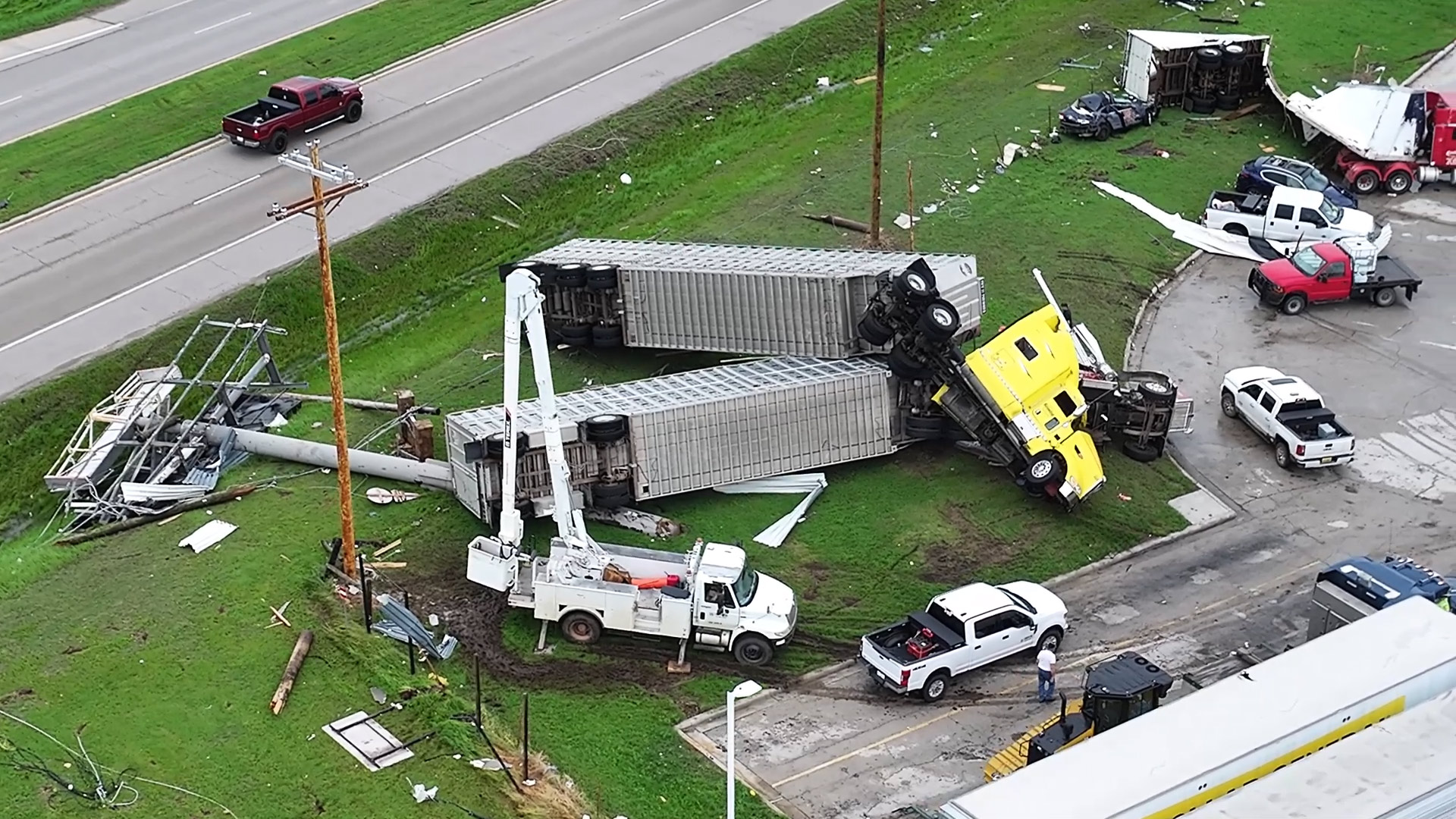 Two semi-trucks stacked atop each other after being lifted by the powerful winds of a violent tornado.