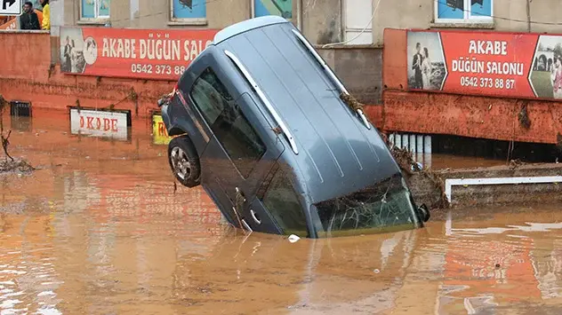 A car almost vertical in the flood water in Sanliurfa.