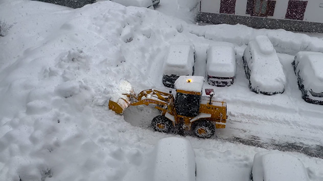 Tractor clears snow from road