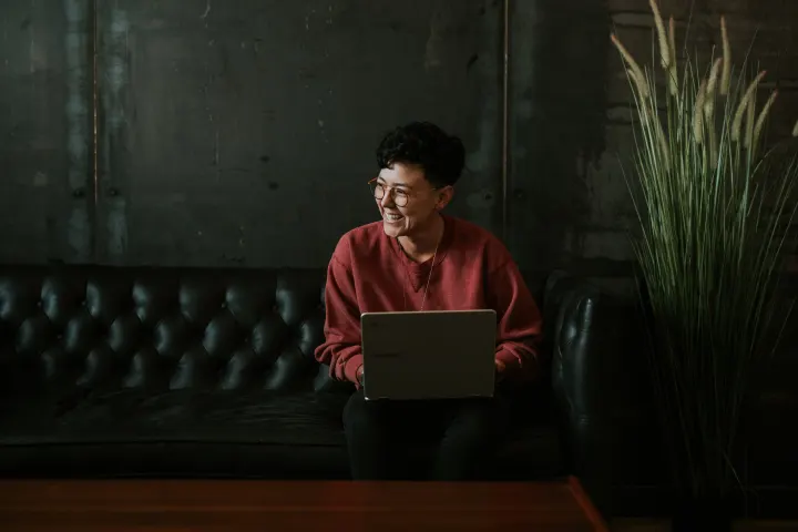 Engineer sitting on a leather couch in a dark room