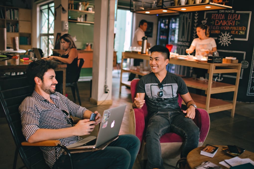 People in conversation in the office lounge area