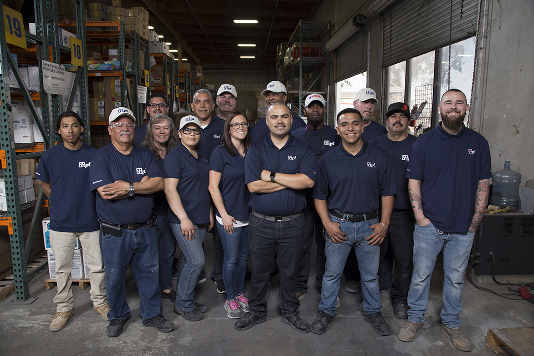 POOLCORP group photo in a warehouse