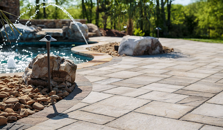 A large swimming pool is surrounded by a wooden deck