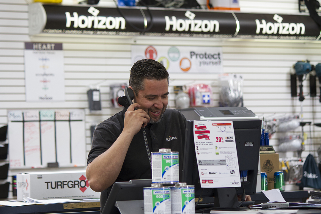 POOLCORP empoloyee on the phone in a store