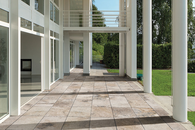 A large swimming pool is surrounded by a wooden deck
