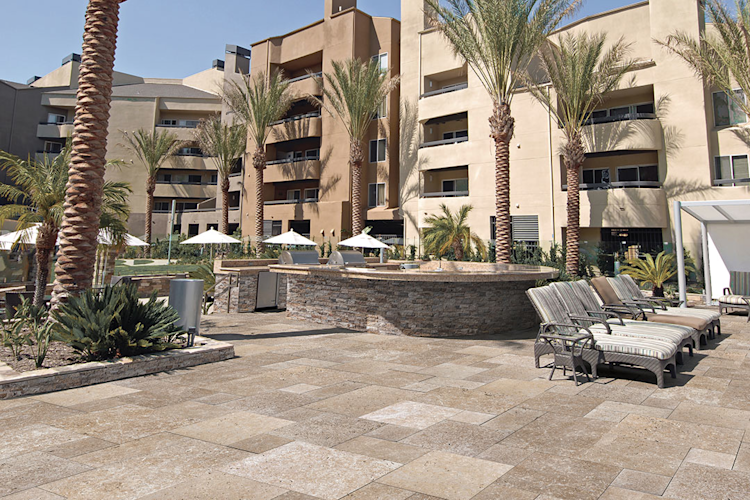 A large swimming pool is surrounded by a wooden deck