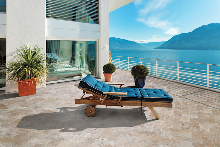 A large swimming pool is surrounded by a wooden deck