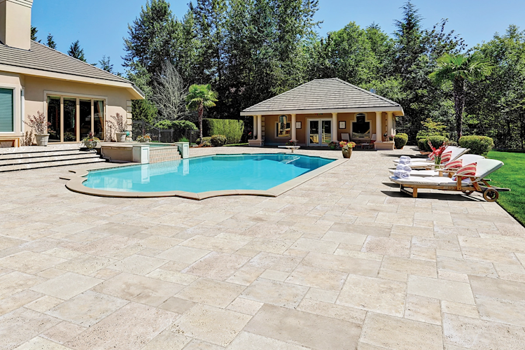 A large swimming pool is surrounded by a wooden deck