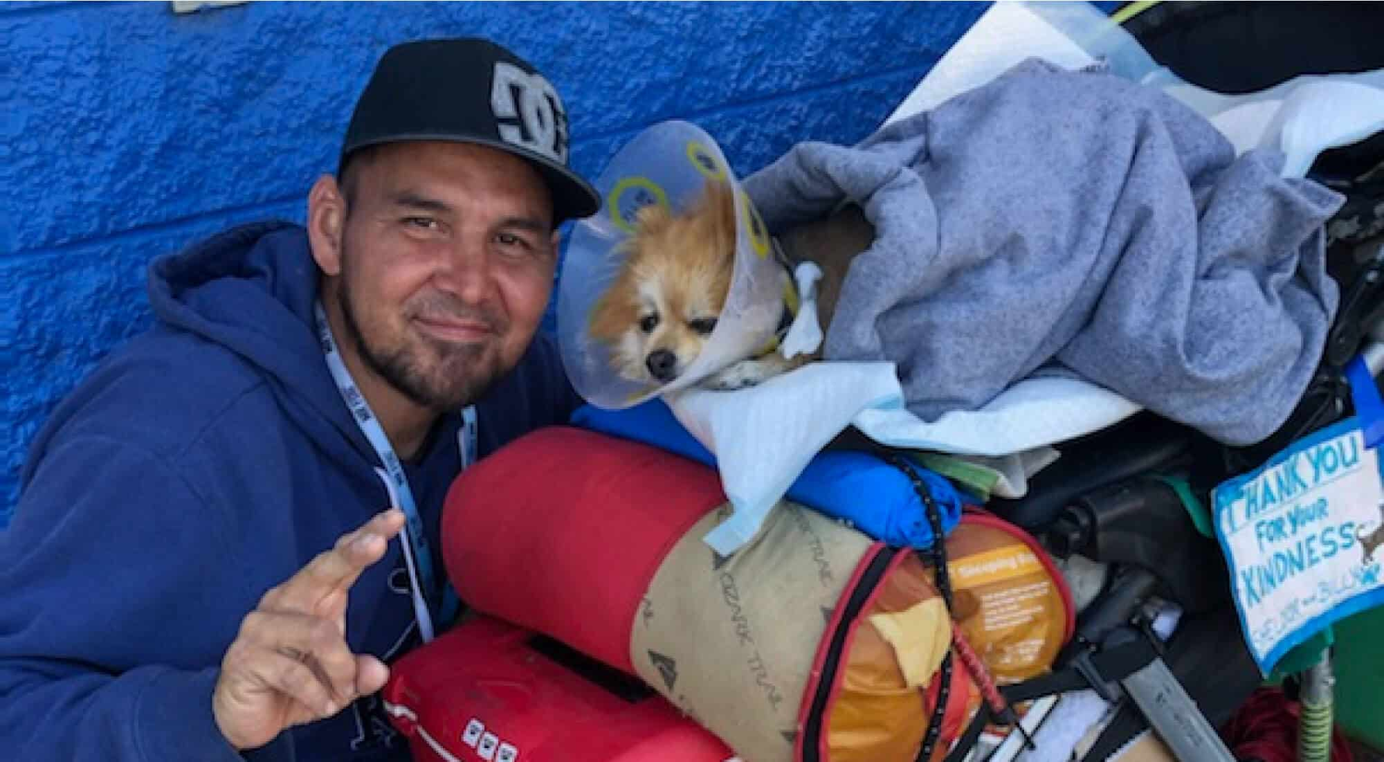 man with dog wrapped on a blanket