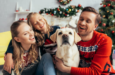 Happy family sitting with their dog