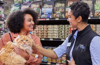 A devoted pet lover and her pet cat are helped at a Pet Valu store by a pet valu employee