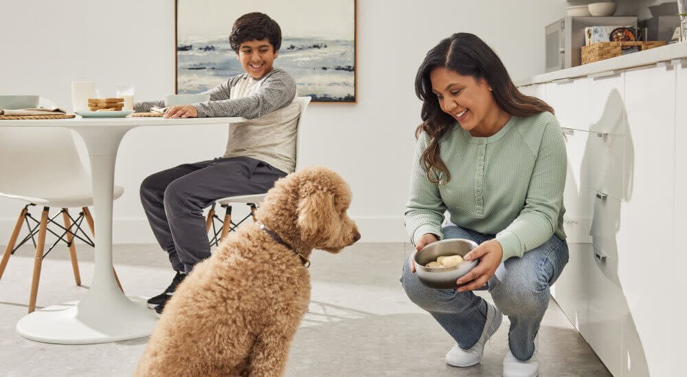 A DPL and her son offer raw food to their furry BFF.