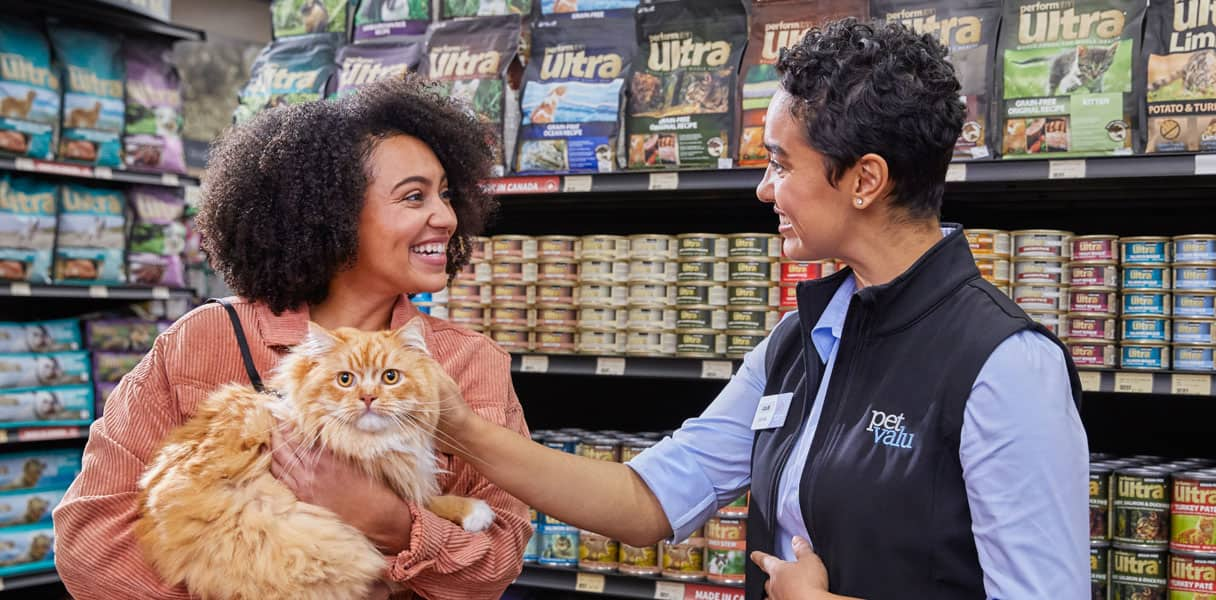 A devoted pet lover and her pet cat are helped at a Pet Valu store by a pet valu employee