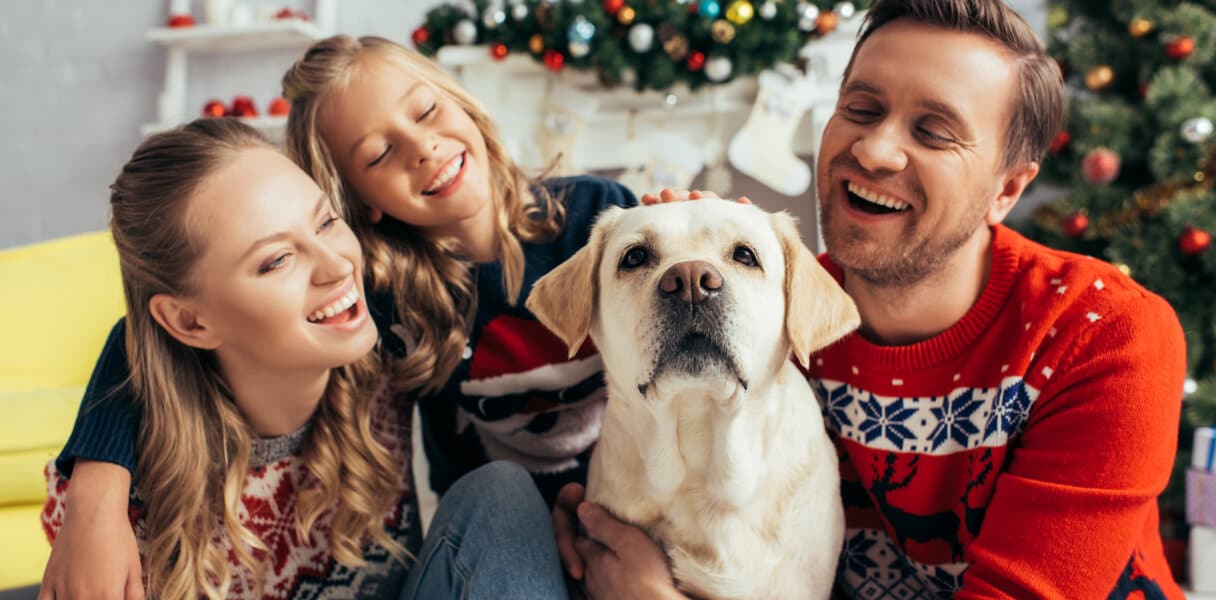 Happy family sitting with their dog