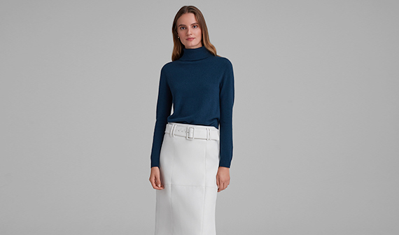 woman in blue sweater and white skirt