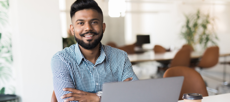 South Asian man at laptop