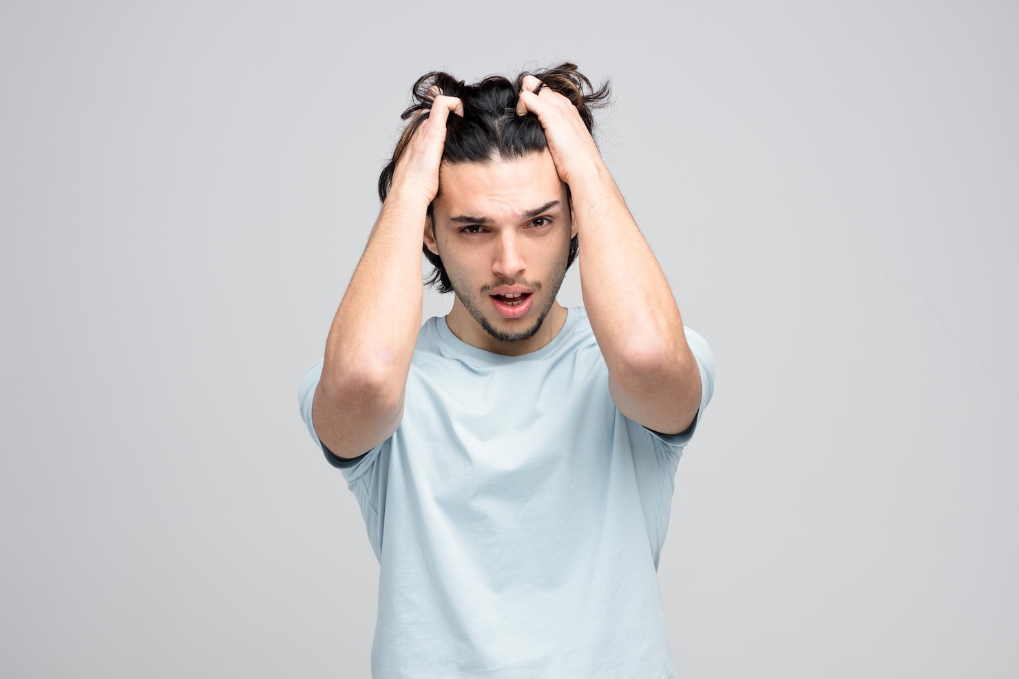 stressed-young-handsome-man-keeping-hands-head-grabbing-his-hair-while-looking-camera-isolated-white-background 141793-133112