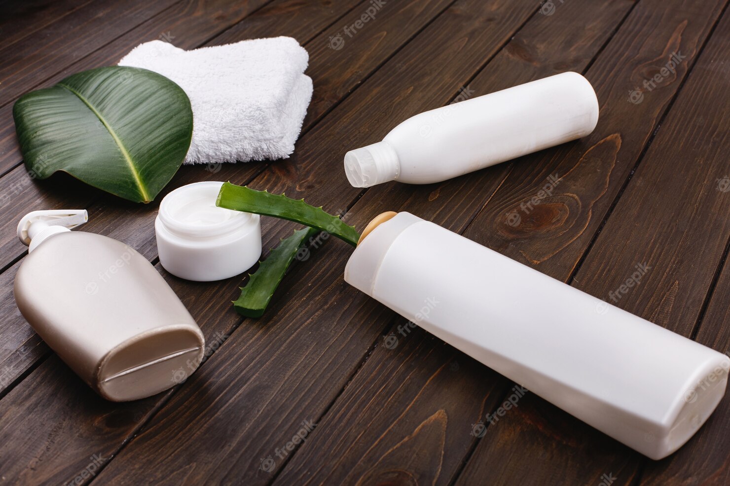 white-towel-bottles-shampoo-conditioner-lie-table-with-green-leaf-aloe 8353-7050