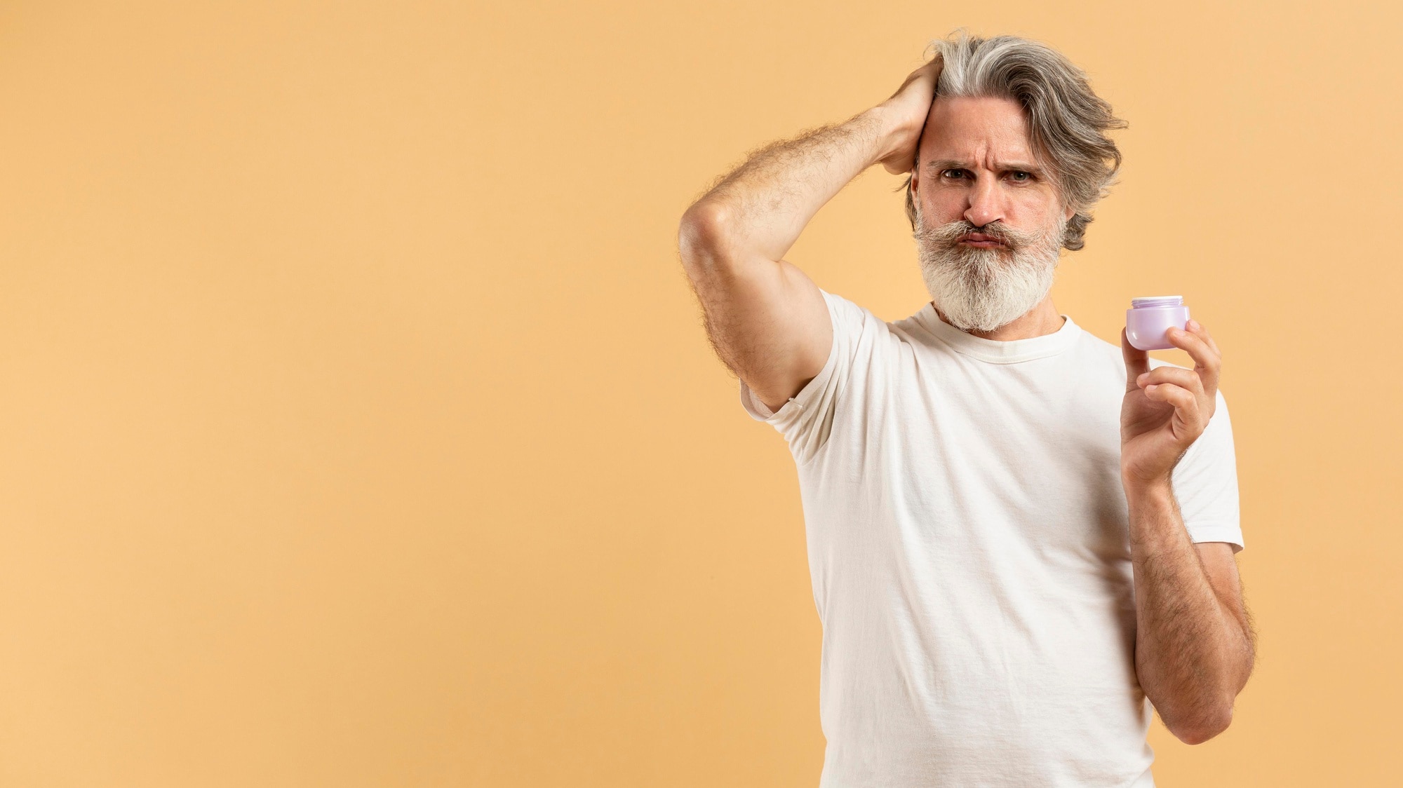 front-view-elder-bearded-man-holding-hair-gel-with-copy-space 23-2148621172